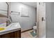 Bathroom features a modern vanity, tiled shower, and neutral-toned tiles at 1796 Harbor Dr, Clearwater, FL 33755