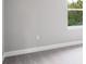 Empty bedroom corner with gray walls and carpet at 2612 Leafwing Ct, Palm Harbor, FL 34683