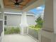 Covered porch with white columns, ceiling fan, and view of backyard at 2612 Leafwing Ct, Palm Harbor, FL 34683