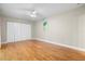 Bedroom with hardwood floors and double door closet at 303 Windrush Loop, Tarpon Springs, FL 34689