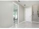 Bright entryway with marble-look flooring, leading to living areas and staircase at 3845 Seena Manor Ct, Tampa, FL 33618