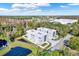 Aerial view of a modern townhome community with a pond and lush trees nearby at 3845 Seena Manor Ct, Tampa, FL 33618