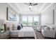 Bright and airy main bedroom with large windows, plush carpeting, and seating area at 3845 Seena Manor Ct, Tampa, FL 33618