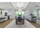 Open concept dining room with hardwood floors, large table, and access to kitchen at 3845 Seena Manor Ct, Tampa, FL 33618