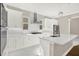 Modern kitchen with white cabinets, stainless steel appliances and hardwood floor at 3845 Seena Manor Ct, Tampa, FL 33618