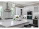 Spacious kitchen featuring white cabinets, stainless steel appliances, and a large island at 3845 Seena Manor Ct, Tampa, FL 33618