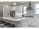 Bright kitchen boasts white cabinets, stainless steel appliances, and an island at 3845 Seena Manor Ct, Tampa, FL 33618