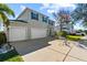 Two-story house with a three-car garage and well-manicured lawn at 5434 Sandy Shell Dr, Apollo Beach, FL 33572