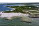 Aerial view of a serene beach area with gentle waves and natural surroundings at 6512 Bimini Ct, Apollo Beach, FL 33572