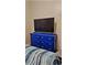 Bedroom featuring a dark blue dresser with a modern tv at 10006 N Mitchell Ave, Tampa, FL 33612