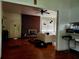 Spacious living room featuring a brick fireplace and hardwood floors at 10006 N Mitchell Ave, Tampa, FL 33612