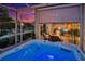 Relax in this covered lanai hot tub with sunset views at 1647 Emerald Dunes Dr, Sun City Center, FL 33573