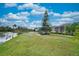 Spacious backyard with canal view and lush landscaping at 1647 Emerald Dunes Dr, Sun City Center, FL 33573