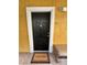 Black front door with welcome mat and bench at 1910 E Palm Ave # 13102, Tampa, FL 33605