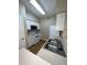 Galley kitchen with white appliances at 1910 E Palm Ave # 13102, Tampa, FL 33605