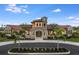 Exterior of community clubhouse with Spanish tile roof and stone accents at 20345 Symphony Pl, Venice, FL 34293