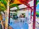 Covered patio area with tables and chairs near the pool at 2060 Marilyn St # 239, Clearwater, FL 33765