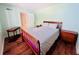 Bedroom with wood-look flooring, nightstands, and access to bathroom at 2060 Marilyn St # 239, Clearwater, FL 33765