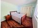 Bedroom with wood-look flooring, double closet and nightstand at 2060 Marilyn St # 239, Clearwater, FL 33765