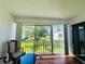 Bright balcony with sliding glass door offering views of trees and community green space at 2060 Marilyn St # 239, Clearwater, FL 33765