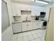 Updated kitchen featuring white shaker cabinets and granite at 2060 Marilyn St # 239, Clearwater, FL 33765