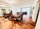 Open-concept dining area with a large table, seating for eight, and hardwood flooring at 2060 Marilyn St # 239, Clearwater, FL 33765