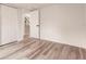 Bright bedroom with wood-look floors and access to stairs at 21048 Peachland Blvd, Port Charlotte, FL 33954