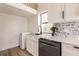 Modern kitchen with white cabinets, stainless steel appliances, and a farmhouse sink at 21048 Peachland Blvd, Port Charlotte, FL 33954