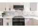 Modern kitchen with white cabinets, stainless steel appliances, and quartz countertops at 21048 Peachland Blvd, Port Charlotte, FL 33954