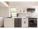 Modern kitchen with white cabinets, stainless steel appliances, and quartz countertops at 21048 Peachland Blvd, Port Charlotte, FL 33954