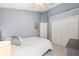 Bedroom with a queen-size bed and double doors to closet at 2457 Hickman Cir, Clearwater, FL 33761