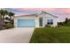 Modern single story home with light blue garage door at 285 Porto Alegre St, Punta Gorda, FL 33983