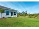 View of the house's backyard with a grassy area at 285 Porto Alegre St, Punta Gorda, FL 33983