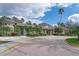 Community clubhouse with palm trees and circular driveway at 2953 Willowleaf Ln, Wesley Chapel, FL 33544