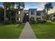 Two-story condo building with lush landscaping at 356 Moorings Cove Dr # 356, Tarpon Springs, FL 34689