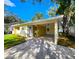 Front view of the house with carport and landscaping at 3915 W San Pedro St, Tampa, FL 33629