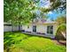 House back view, showcasing sliding doors and a green lawn at 3915 W San Pedro St, Tampa, FL 33629