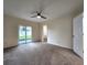 Main bedroom with sliding glass doors, ceiling fan and en-suite bathroom at 3915 W San Pedro St, Tampa, FL 33629
