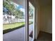 View of backyard through sliding glass doors from bedroom at 3915 W San Pedro St, Tampa, FL 33629