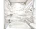 Updated bathroom with bathtub, shower, and marble-style tile at 3915 W San Pedro St, Tampa, FL 33629
