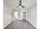 Spacious bedroom with ceiling fan, double-door closet, and access to hallway at 3915 W San Pedro St, Tampa, FL 33629