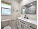 Modern bathroom with white vanity, black hardware, and marble tile at 3915 W San Pedro St, Tampa, FL 33629