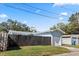 Detached garage with white door and dark fence at 4237 Dr Martin Luther King Jr N St, St Petersburg, FL 33703