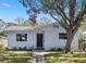 Charming light blue house with a dark brown door and landscaped yard at 4237 Dr Martin Luther King Jr N St, St Petersburg, FL 33703