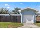 Single car garage with white door and light blue exterior at 4237 Dr Martin Luther King Jr N St, St Petersburg, FL 33703