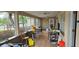 Enclosed porch with tiled floor and seating at 7054 Hibiscus S Ave, South Pasadena, FL 33707