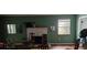 Living room with fireplace and green walls at 7054 Hibiscus S Ave, South Pasadena, FL 33707