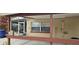 Exterior view showcasing a covered patio and screened porch at 7054 Hibiscus S Ave, South Pasadena, FL 33707