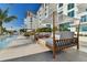 Relaxing pool area with comfortable lounge chairs and shade structures at 1020 Sunset Point Rd Rd # 405, Clearwater, FL 33755