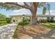 Attractive exterior of the house with mature tree and landscaping at 1214 Haddington Cir # 1214, Sun City Center, FL 33573